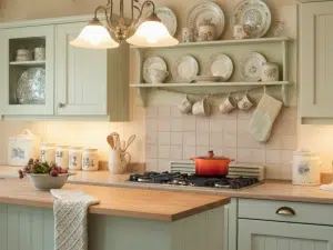 Cottage-style kitchen with vintage accents, painted cabinets, efficient layout.