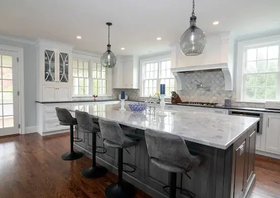 Spacious kitchen with a beige granite island, illustrating a smooth, easy-to-clean surface for low-maintenance care.