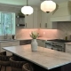 Bright Connecticut kitchen upgrade featuring a pendant-lit marble island, pro-style range, and warm under-cabinet task lighting.