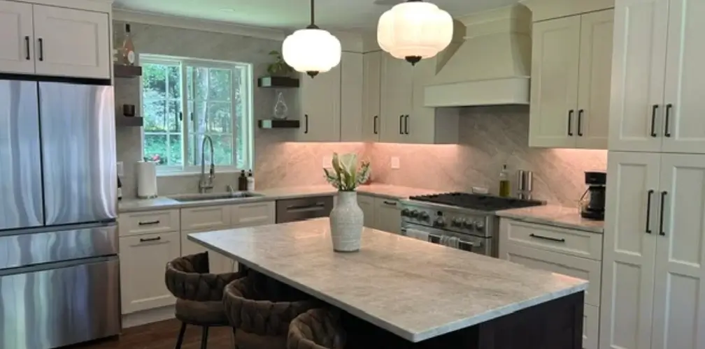 kitchen-upgrade-modern-remodel Bright Connecticut kitchen upgrade featuring a pendant-lit marble island, pro-style range, and warm under-cabinet task lighting.