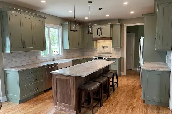 kitchen-bathroom-renovation Kitchen Traditions renovation inspiration for CT homeowners: green shaker kitchen, stained wood island, apron-front sink under a window and oak floors.